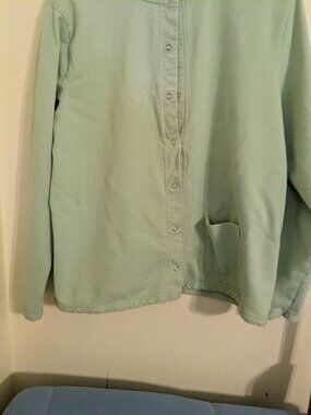 Light green top/jacket.
